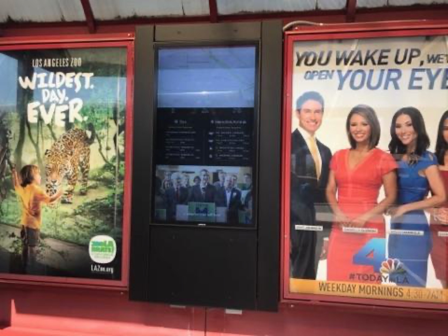 Digital transit information screen at a Los Angeles bus shelter